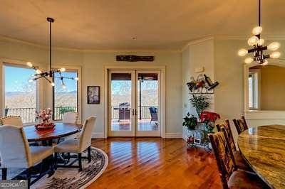 dining room with french doors, ornamental molding, a chandelier, and hardwood / wood-style floors