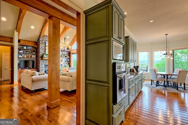 4431 Furman Gribble Rd, Young Harris, GA 30582 - kitchen featuring green cabinetry, a chandelier, appliances with stainless steel finishes, hardwood / wood-style floors, and crown molding