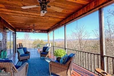 sunroom featuring ceiling fan and wood ceiling