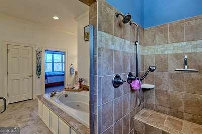 bathroom featuring separate shower and tub