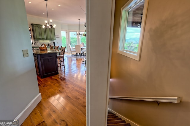 4431 Furman Gribble Rd, Young Harris, GA 30582 - hall with a chandelier, baseboards, wood finished floors, ornamental molding, and recessed lighting