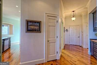 corridor featuring ornamental molding and light wood-type flooring