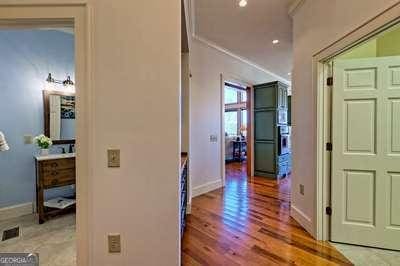 corridor with crown molding and hardwood / wood-style flooring