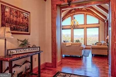 interior space with hardwood / wood-style flooring, lofted ceiling, and a notable chandelier