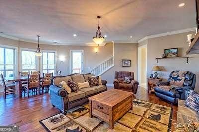 living room featuring crown molding and wood-type flooring