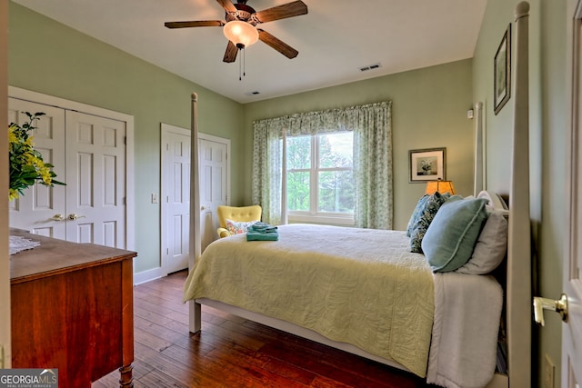 4431 Furman Gribble Rd, Young Harris, GA 30582 - bedroom with dark wood-style flooring, two closets, baseboards, and ceiling fan