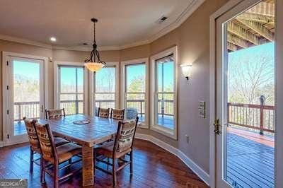 dining room with dark wood-type flooring and ornamental molding