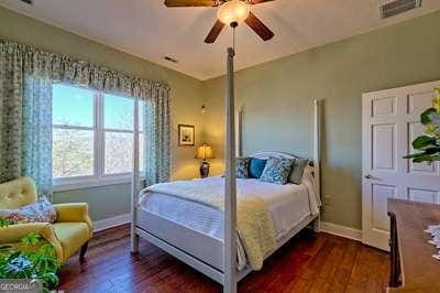 bedroom with ceiling fan and dark hardwood / wood-style flooring