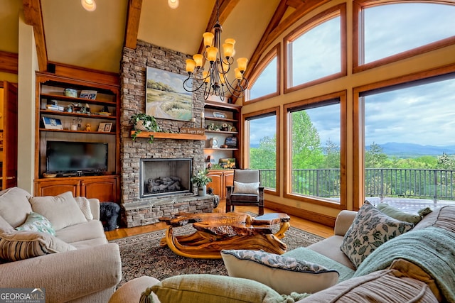 4431 Furman Gribble Rd, Young Harris, GA 30582 - living room featuring a chandelier, high vaulted ceiling, built in shelves, wood finished floors, and beamed ceiling