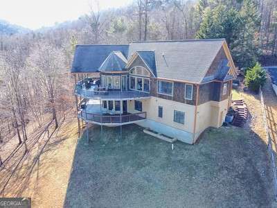 rear view of property with a yard