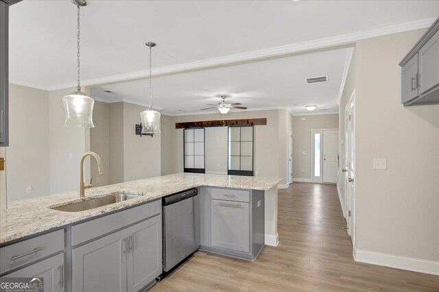 kitchen with gray cabinets, a wealth of natural light, sink, stainless steel appliances, and light stone countertops