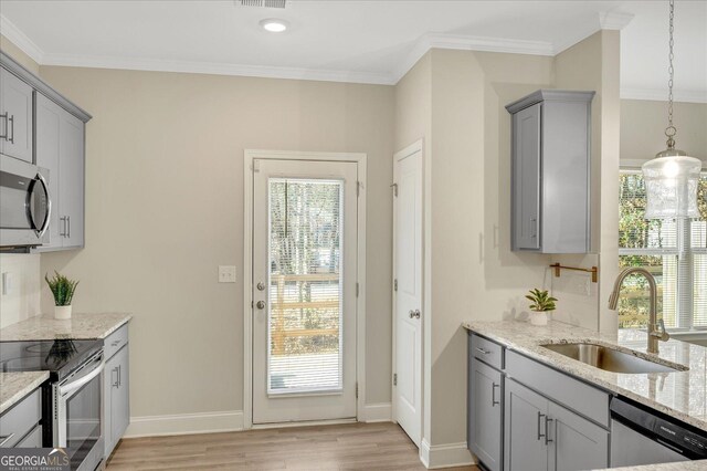 stairway with crown molding, ceiling fan with notable chandelier, and hardwood / wood-style flooring