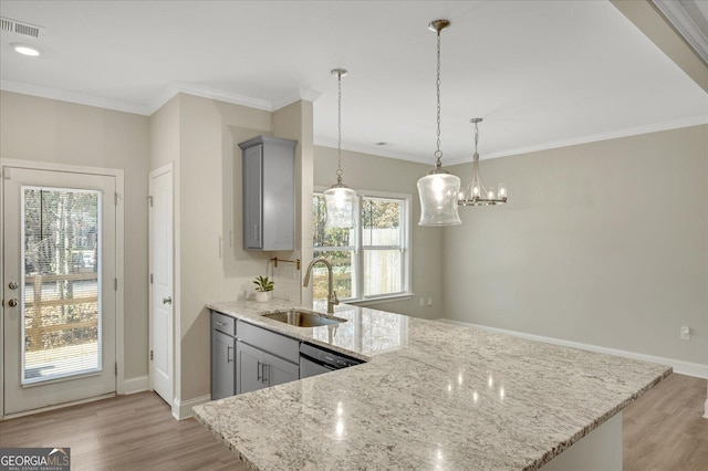 kitchen with gray cabinets, light stone countertops, sink, and decorative light fixtures