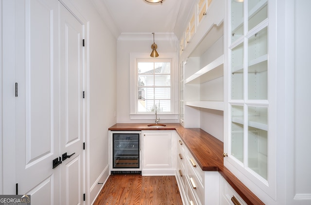 bar with white cabinetry, butcher block counters, dark wood-type flooring, and wine cooler