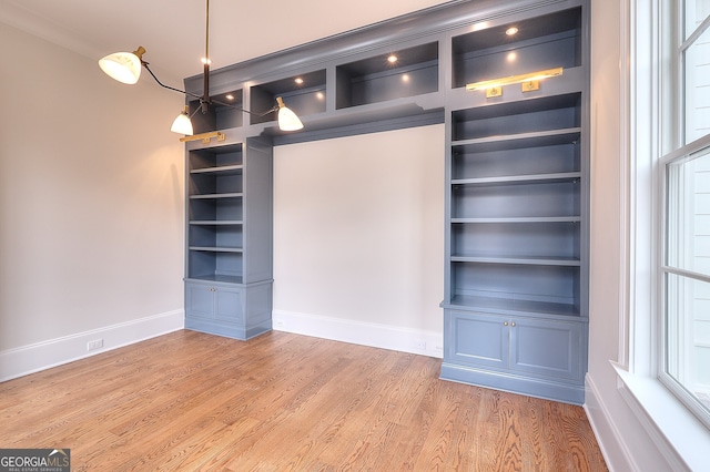 interior space featuring hardwood / wood-style floors and built in shelves