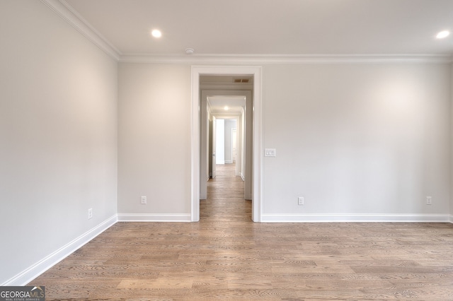 unfurnished room with wood-type flooring and crown molding