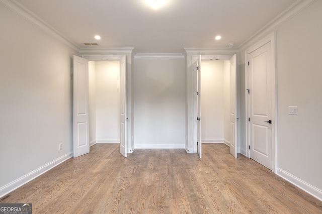 unfurnished bedroom featuring ornamental molding and light wood-type flooring