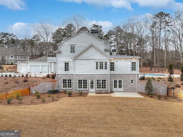 back of house with central AC, french doors, a yard, a fenced in pool, and a patio