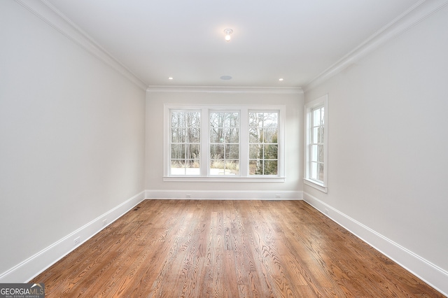 spare room featuring crown molding and wood-type flooring