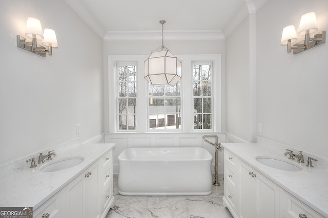 bathroom with vanity, a tub, and crown molding