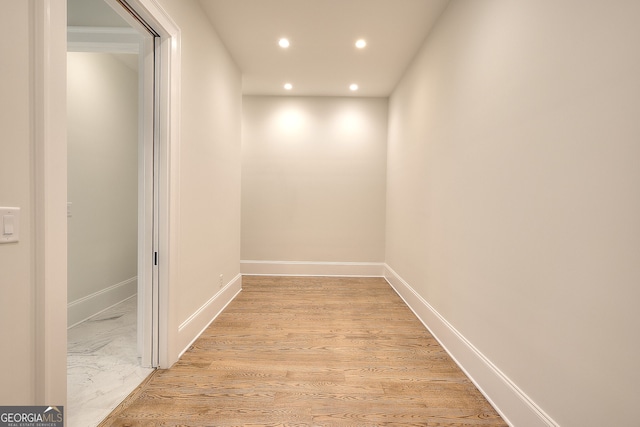 hallway with light hardwood / wood-style floors