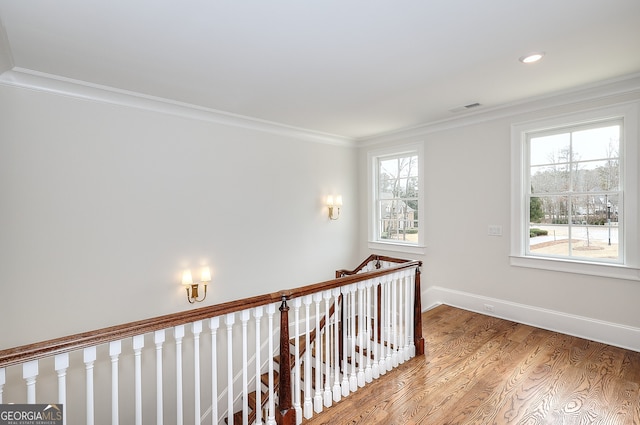 hall with crown molding and light wood-type flooring