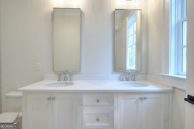 bathroom featuring vanity and toilet