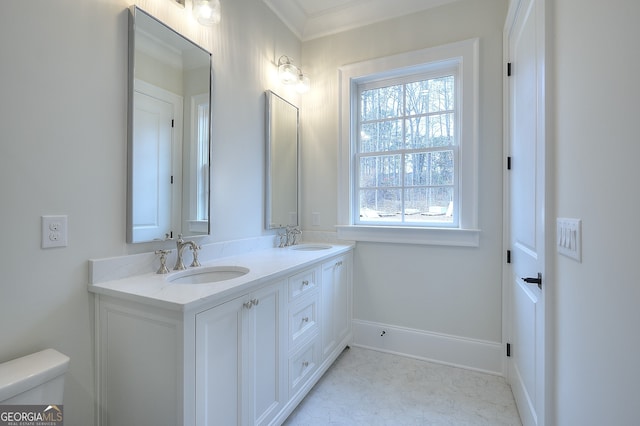 bathroom with a healthy amount of sunlight, toilet, and vanity