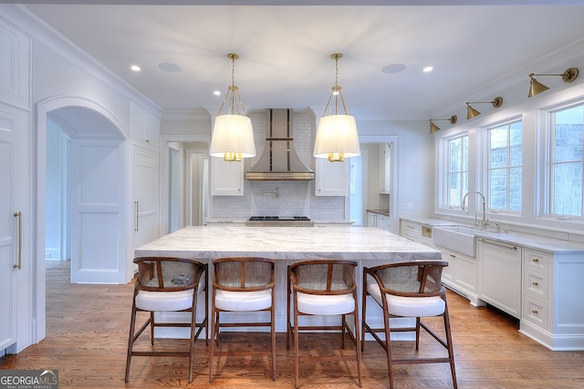 kitchen featuring sink, extractor fan, light stone counters, white cabinetry, and dishwasher