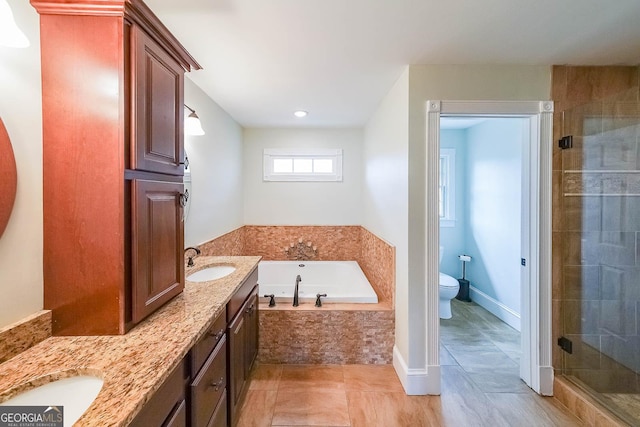 bathroom with toilet, tile patterned flooring, vanity, a shower stall, and a bath