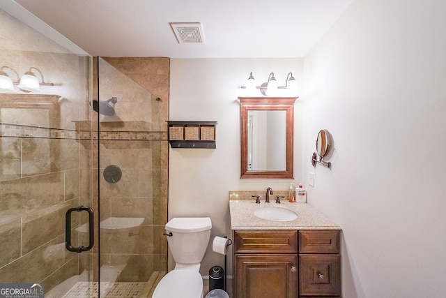 full bathroom featuring toilet, a stall shower, visible vents, and vanity