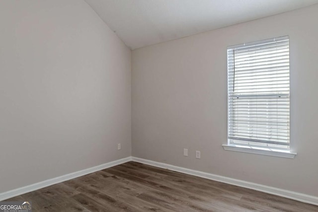 unfurnished room featuring dark hardwood / wood-style flooring and plenty of natural light