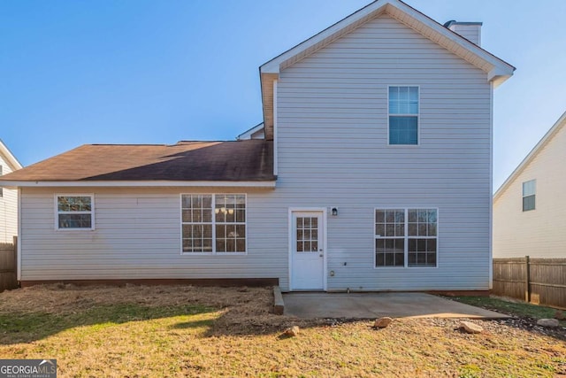 back of house featuring a yard and a patio