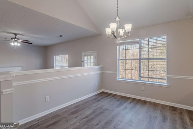 unfurnished room with ceiling fan with notable chandelier, wood-type flooring, a textured ceiling, and vaulted ceiling