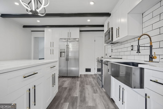 kitchen featuring white cabinetry and stainless steel appliances