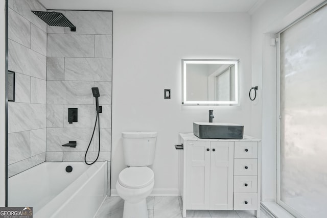 full bathroom featuring tiled shower / bath, vanity, and toilet