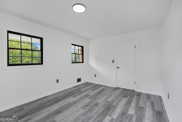 spare room with light hardwood / wood-style flooring