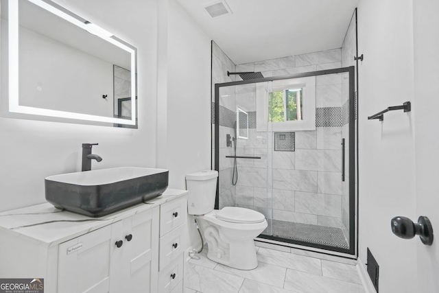 bathroom featuring vanity, walk in shower, and toilet