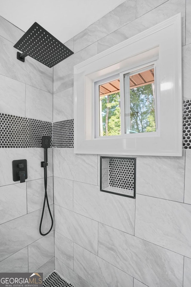 bathroom with a tile shower