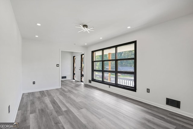 spare room with light hardwood / wood-style flooring and ceiling fan