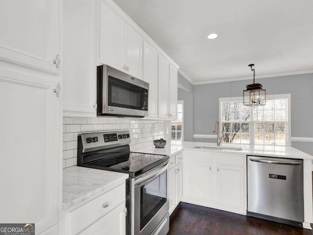 kitchen with crown molding, stainless steel appliances, sink, and white cabinets