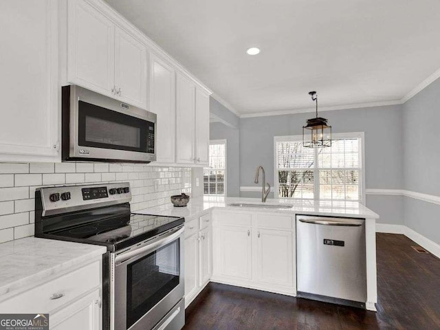 kitchen with white cabinetry, appliances with stainless steel finishes, sink, and crown molding