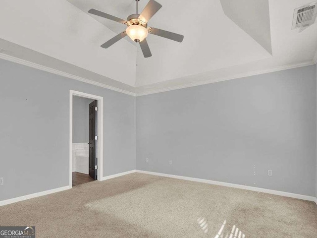 spare room with crown molding, carpet floors, a raised ceiling, and ceiling fan