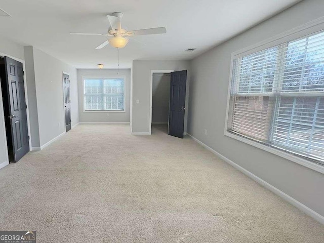 interior space featuring ceiling fan and light carpet