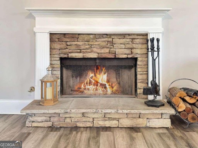 room details with hardwood / wood-style flooring and a fireplace