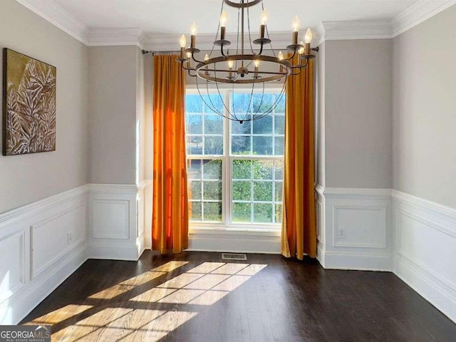 interior space with an inviting chandelier, ornamental molding, and dark hardwood / wood-style floors