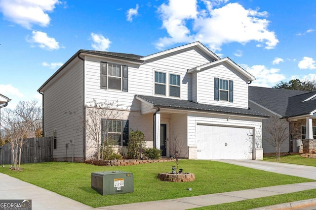 view of front of property featuring a garage and a front yard