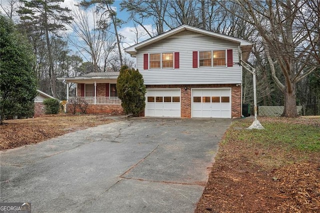 split level home with a garage and a porch