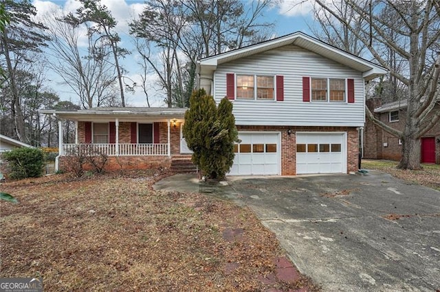 split level home with a garage and covered porch