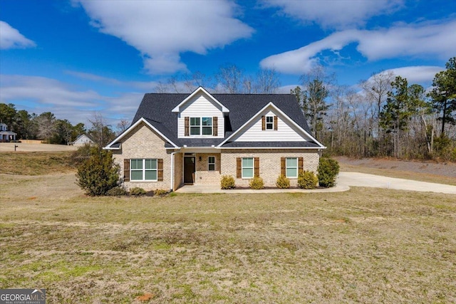 view of front of property featuring brick siding and a front yard